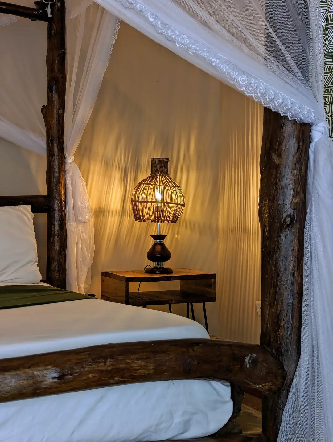 Bedside lamp and canopy bed, Mvuli Mountain Lodge