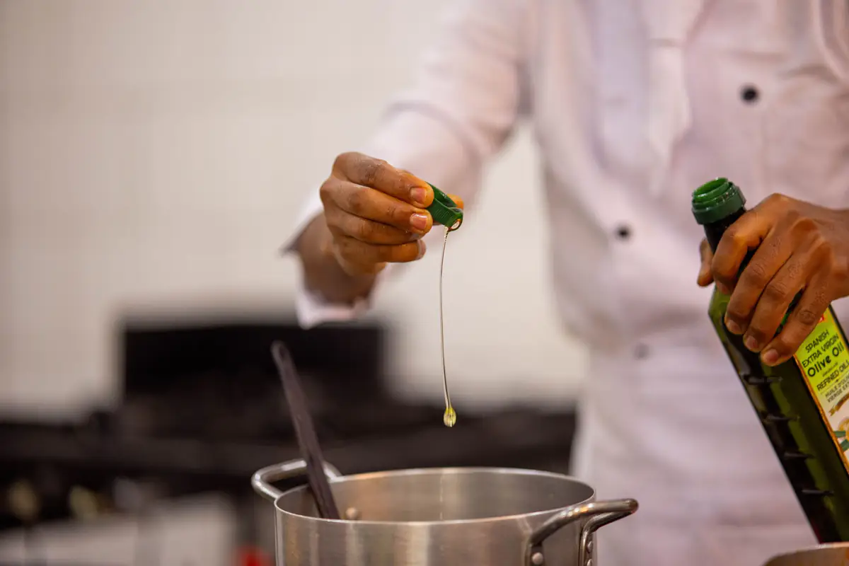 Chef cooking in the kitchen at Mvuli Farm Lodge