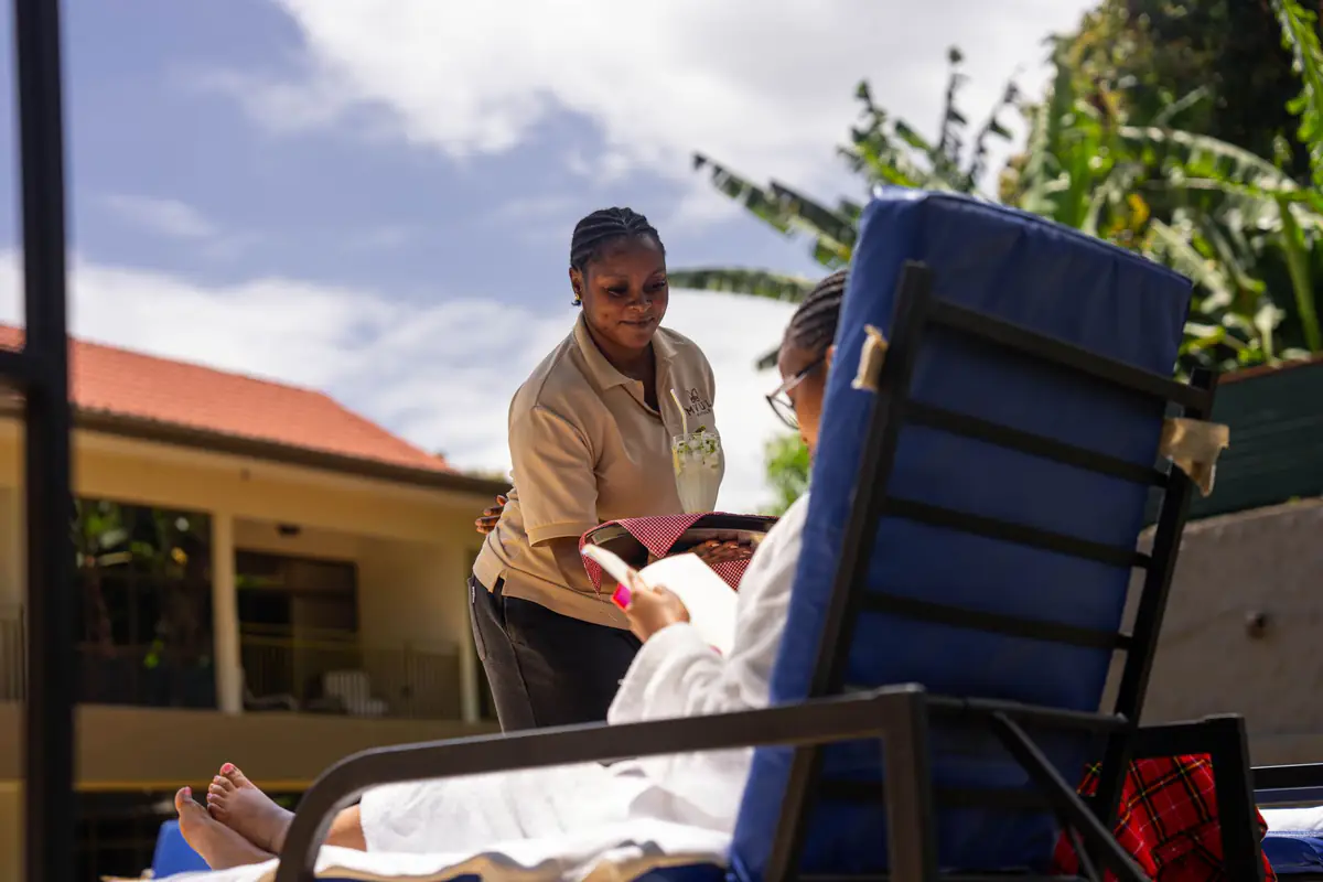 Poolside service for a guest at Mvuli Farm Lodge