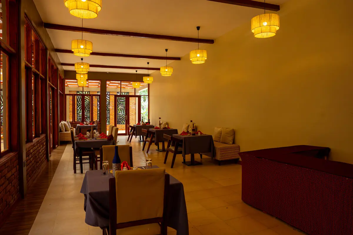 Restaurant lounge with pendant lights at Mvuli Farm Lodge