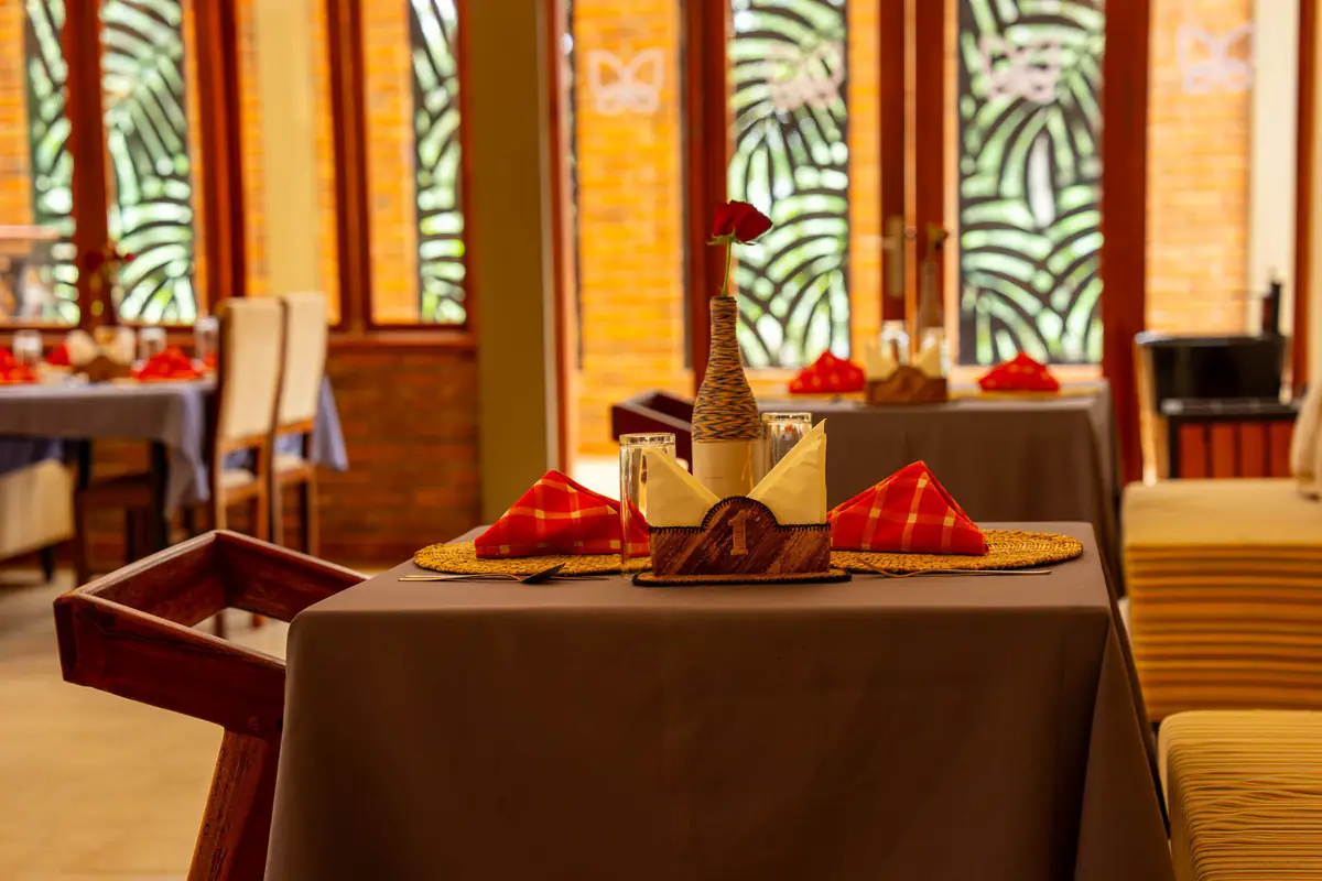 Table set with red napkins at Mvuli Farm Lodge restaurant